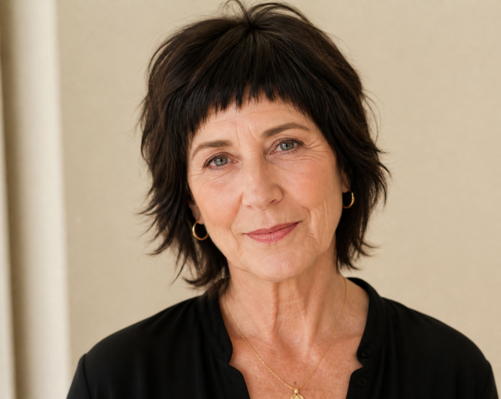 Short shag haircut for women over 50 with soft layered texture, voluminous crown, and wispy bangs adding youthful movement and fullness to thinning hair